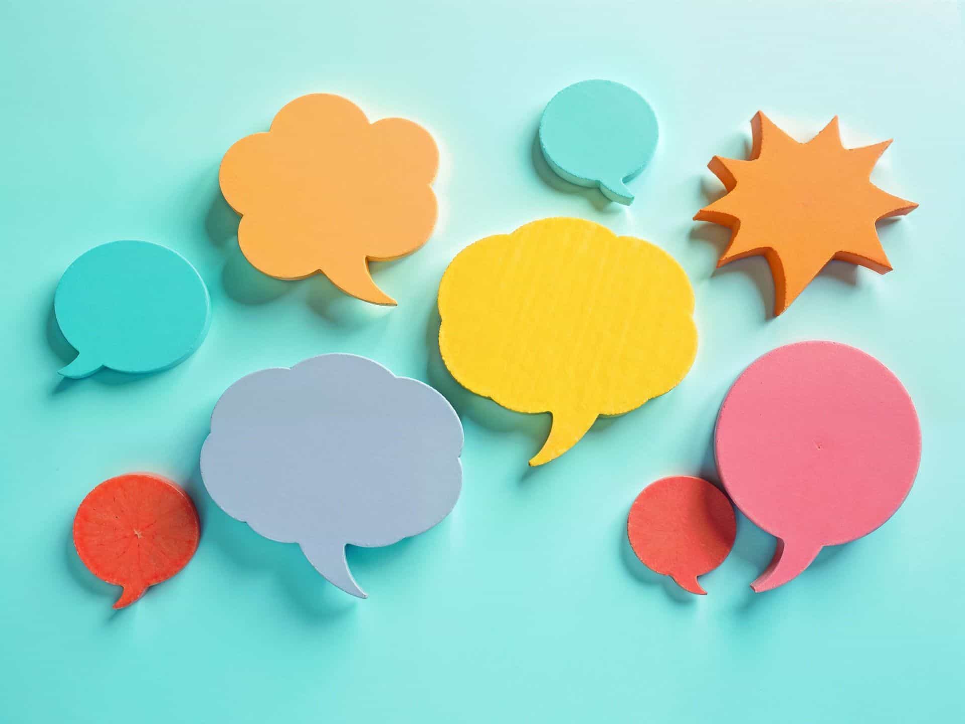 pexels-hamzasamadh-31418369 Vibrant paper cut speech bubbles on a turquoise background, perfect for communication themes